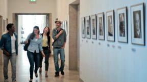 International students walk laughing in a corridor of the university.