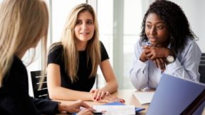 Two students sit during a counselling talk with a university employee.